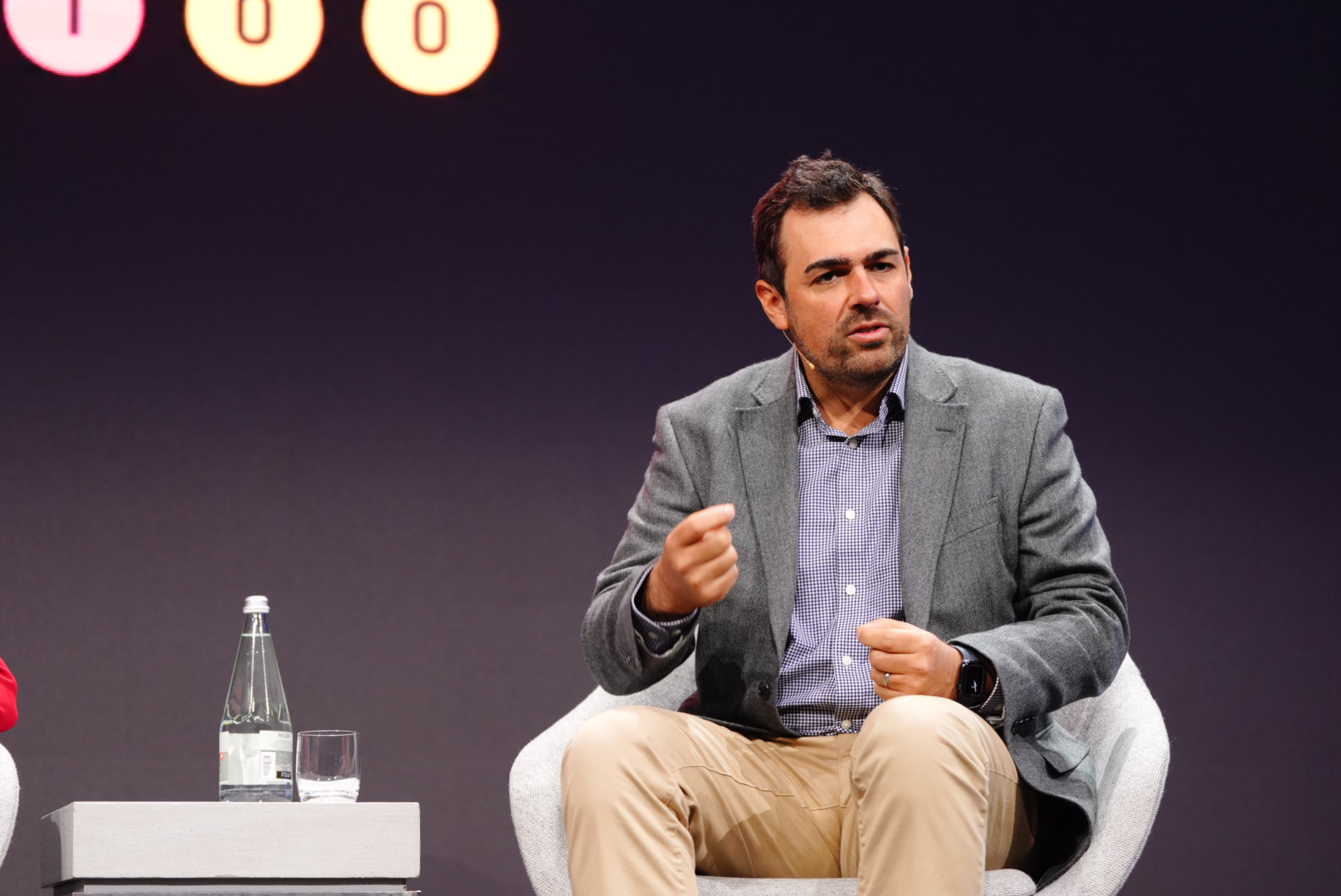 Phil Intallura speaking during a panel discussion, seated with a headset microphone